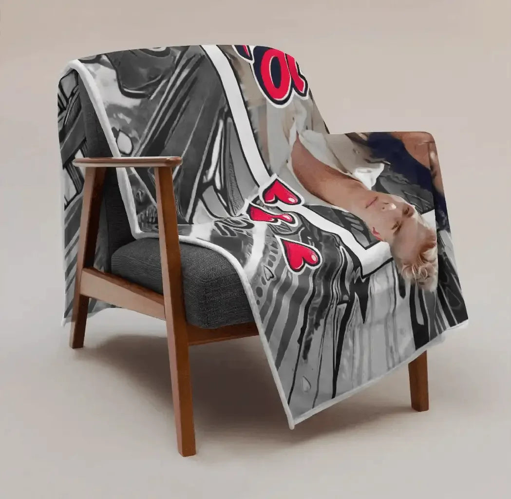 Schmusedecke mit Liebesmotiv, Fotodruck und roten Herzen über grauem Sessel im Wohnzimmer